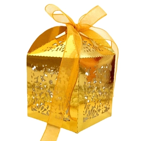 Detailed laser-cut floral pattern on golden gift box with a matching organza ribbon bow