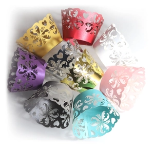 Laser-cut heart and snowflake cupcake wrappers in gold, red, white, and multi-color packs