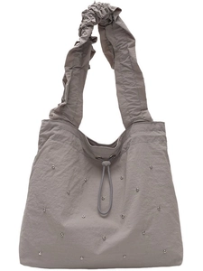 Taupe nylon tote bag with pleated ruffle handles and silver stud details on white background