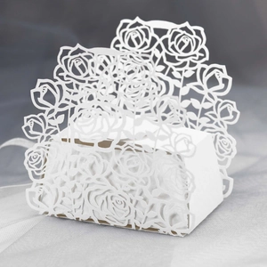 Detailed laser-cut rose patterns on the white paper wedding favor gift box surface