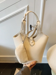 Creamy beige pebble grain bucket bag with matching mini pouch and adjustable strap