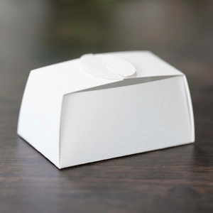 Detail of white laser-cut wedding candy box with elegant top interlocking closure
