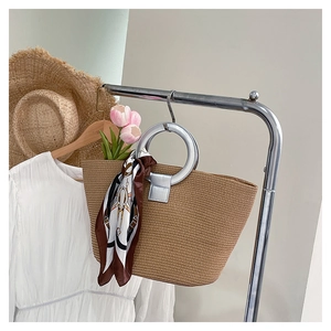 Woven straw tote bag with silver metal ring handles and scarf detail for summer
