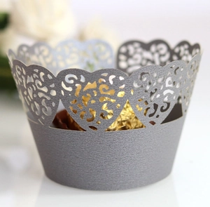 Detail showing laser-cut silver cupcake wrapper with heart and floral hollow patterns