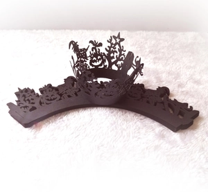 Laser-cut Halloween cupcake wrappers featuring witch, pumpkin and bat silhouette patterns