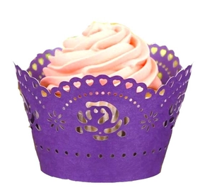 Detail of purple laser-cut cupcake wrapper with hollow floral heart pattern for wedding