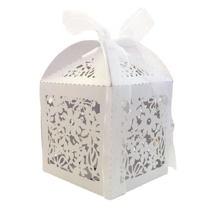 Elegant white laser-cut floral candy box with a delicate organza bow for wedding gifts