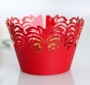 Laser cut red lace cupcake wrapper with elegant filigree vine pattern for wedding decor