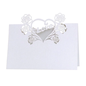 Detailed laser-cut white place card featuring intricate rose patterns and a Love heart design