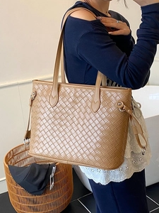 Caramel large woven tote bag for women showing a stylish minimalist shoulder style