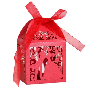 Red laser-cut wedding candy box with bride and groom silhouette and ribbon detail
