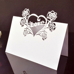 White laser-cut place card with rose and Love heart design for wedding table decor