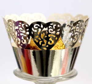 Macro shot of laser-cut heart pattern silver cupcake wrapper with silver metallic finish