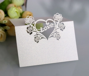 Detail showing the pearlescent laser-cut hollow rose heart and Love design on white table card