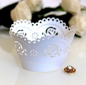 Elegant white laser-cut rose cupcake wrappers for wedding and party decorations