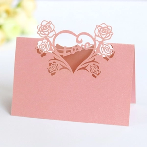 Detail of pink pearlescent laser-cut table card with rose heart and Love design