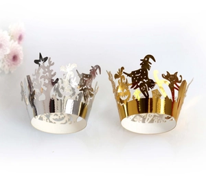 Close-up of laser-cut Halloween cupcake liners with gold and silver castle pumpkin motifs