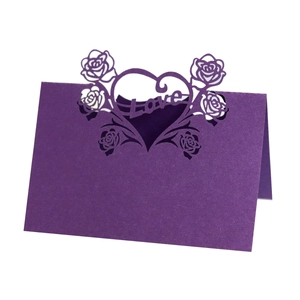 Purple laser-cut place card with rose and heart pattern featuring Love lettering
