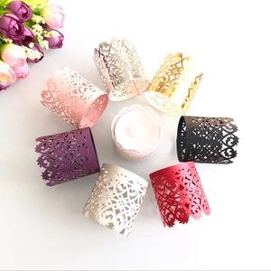Detailed laser-cut paper cupcake wraps and tea light holders in various metallic colors