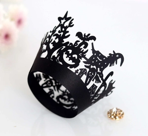 Detailed laser-cut Halloween cupcake wrapper featuring witch, bat and pumpkin patterns