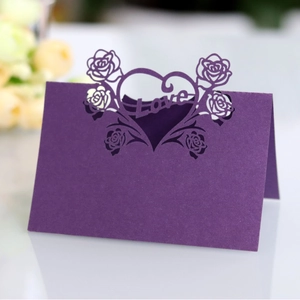 Detailed laser-cut purple place card featuring rose motifs and a hollow Love heart design