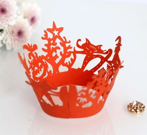 Detailed laser-cut pumpkin and bat patterns on orange Halloween cupcake wrappers