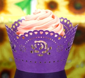 Detail of purple laser-cut cupcake wrapper with floral patterns and heart-shaped edge