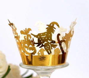 Laser cut Halloween cupcake wrappers in shiny gold featuring witch, pumpkin and bat motifs