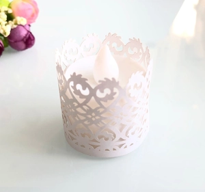 Detailed view of white laser-cut lace paper cover for electronic LED tea light candles