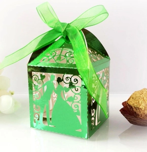 Laser-cut wedding candy box in green metallic cardstock with bride and groom silhouette