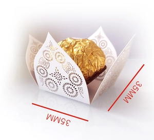 Macro detail of laser-cut wedding candy box with intricate hollow pattern and 35mm base