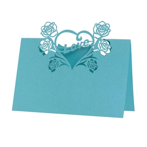 Detailed laser-cut blue table card featuring Love text and intricate rose patterns