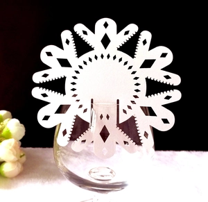Laser cut snowflake place card on wine glass edge for wedding banquet table decor