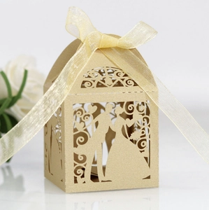 Detail of champagne gold laser-cut wedding candy box with bride and groom silhouette