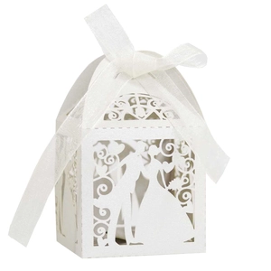 Laser cut wedding favor box detail featuring bride and groom silhouette with white ribbon