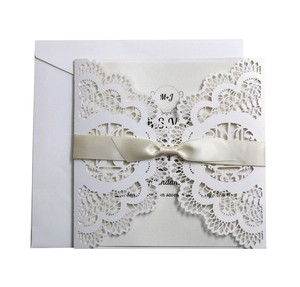 Laser cut white pearl wedding invitation set with lace pattern and elegant ribbon bow