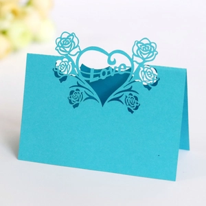 Detail of laser-cut heart and rose pattern on light blue card with Love text design