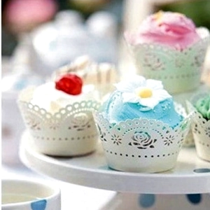 White laser-cut rose paper cupcake wrappers for elegant wedding cake decoration