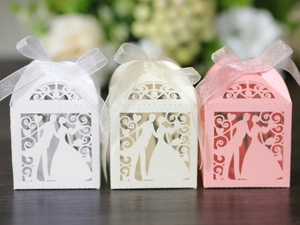 Detailed laser-cut gift boxes with bride and groom silhouettes and ribbon bows