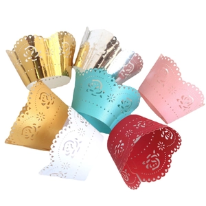 Laser-cut white rose paper cupcake liners in multiple vibrant colors for baking