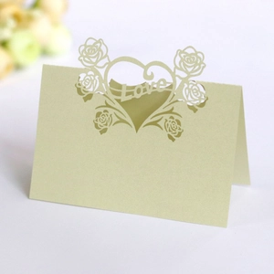 Detail of laser-cut light green wedding place card with rose heart and Love motif