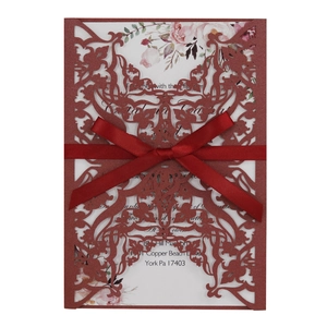 Elegant laser cut burgundy wedding invitation with floral insert and silk ribbon bow