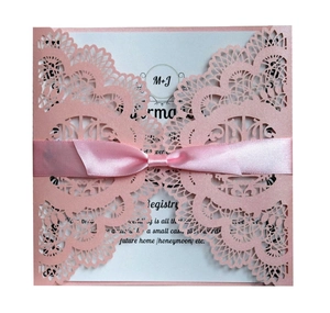 Laser cut lace wedding invitation in soft pink with satin ribbon and M+J initials card