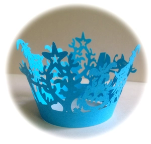 Detailed laser-cut light blue Halloween cupcake wrappers with pumpkin and castle motifs
