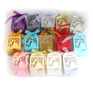 Laser-cut wedding candy boxes in various colors featuring bride and groom silhouettes