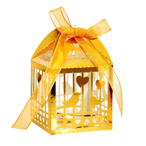 Golden laser-cut birdcage favor box with orange ribbon and heart pattern for weddings