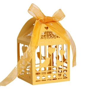 Laser-cut white birdcage wedding favor box with heart patterns and satin ribbon bow
