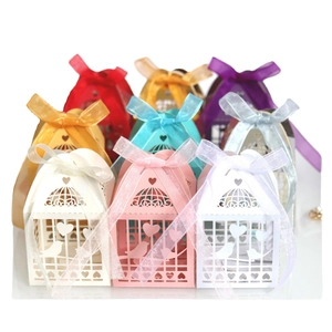 Laser cut bird cage favor boxes with heart patterns and organza ribbons in various colors