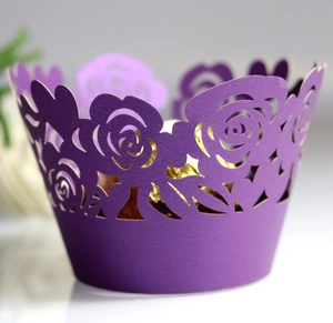 Intricate laser-cut purple paper cupcake wrapper featuring delicate rose patterns for weddings