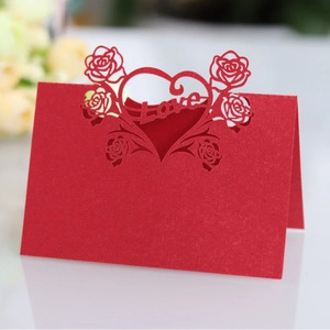 Red laser-cut table card with heart rose patterns and Love text for wedding decor